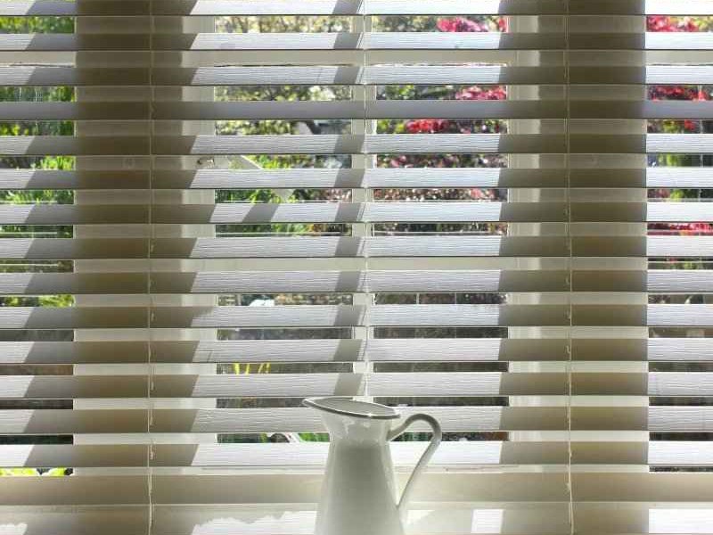 White horizontal blinds in a bright window in SK